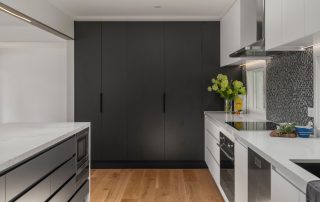 Contemporary kitchen renovation featuring high end stone bechtops